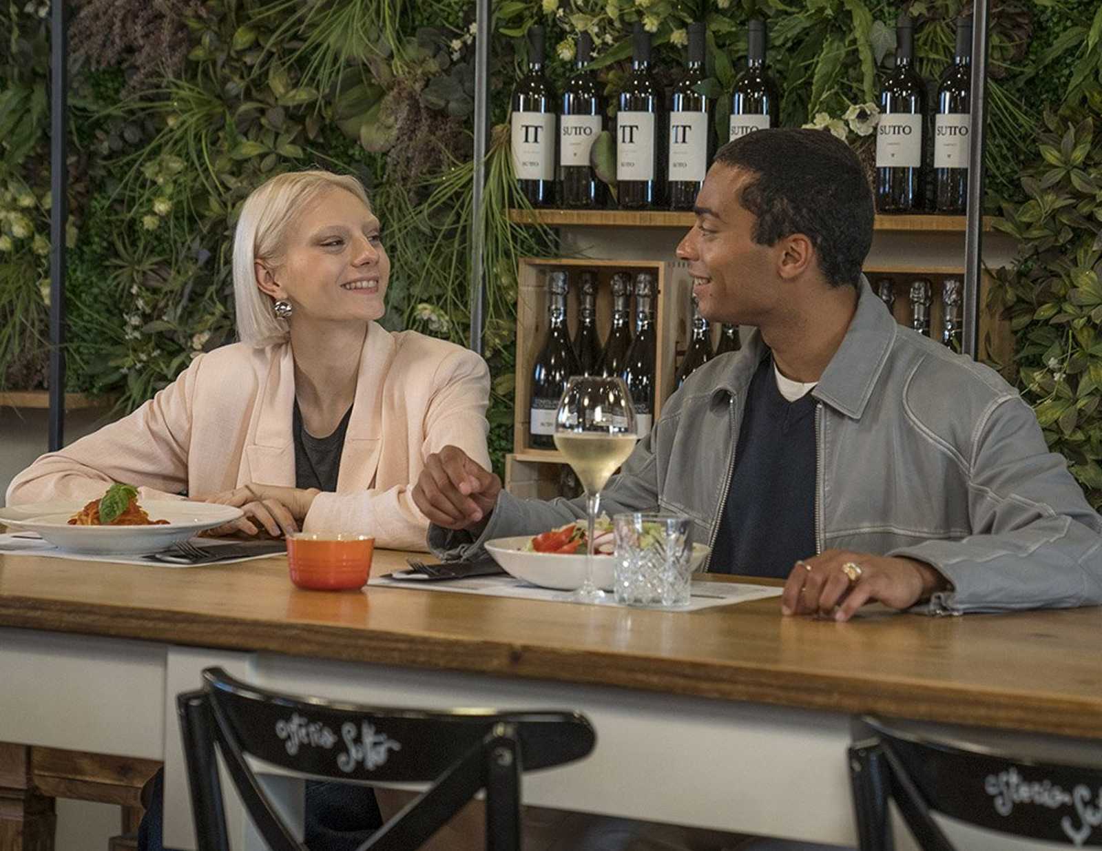 A couple sharing a pasta meal at a restaurant located at Noventa di Piave Designer Outlet.