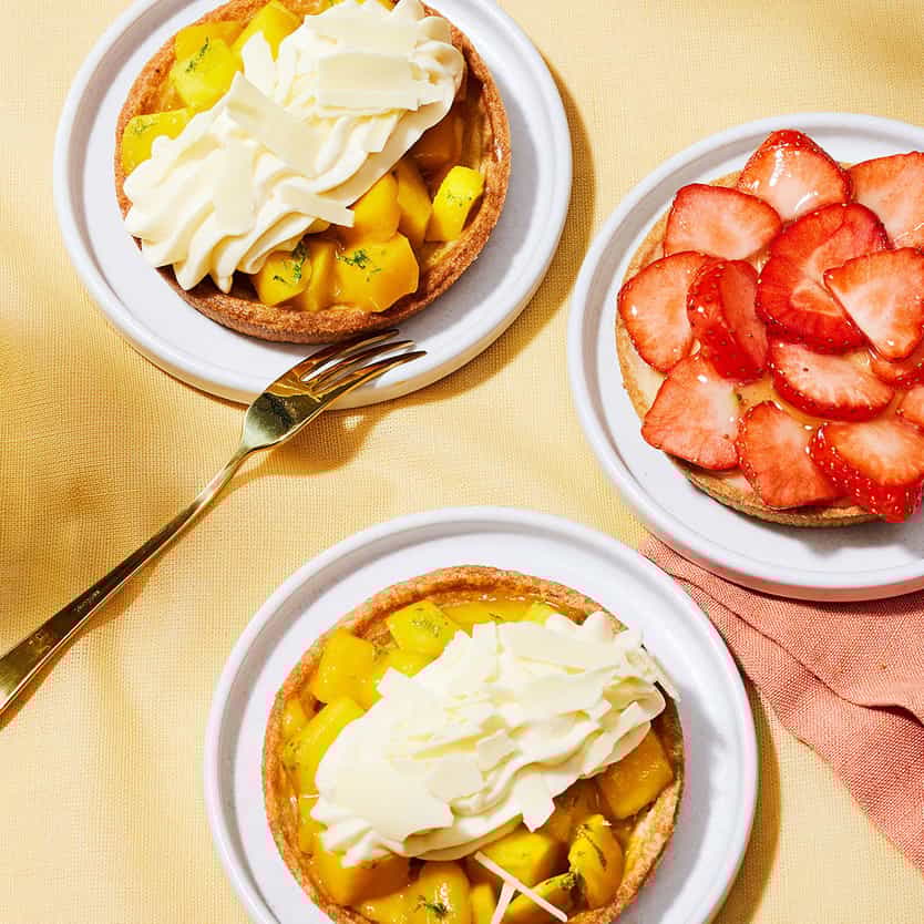 Some delicous tarts with apples and strawberries