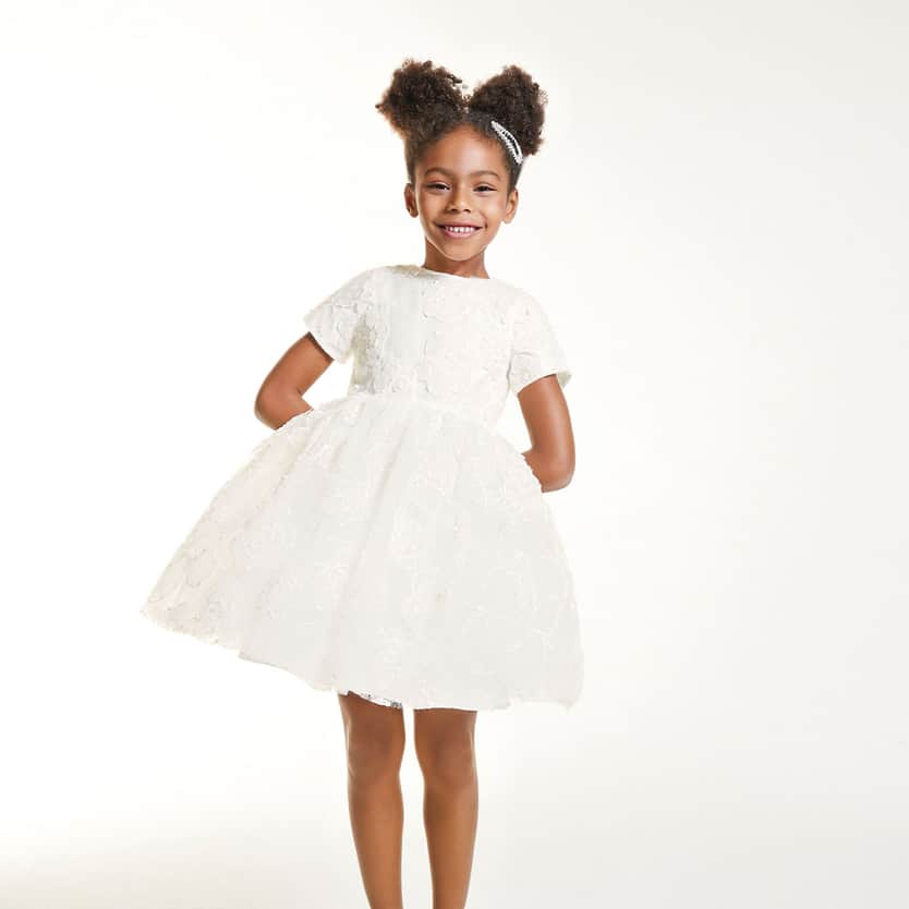 Simonetta baby girl model wearing white dress
